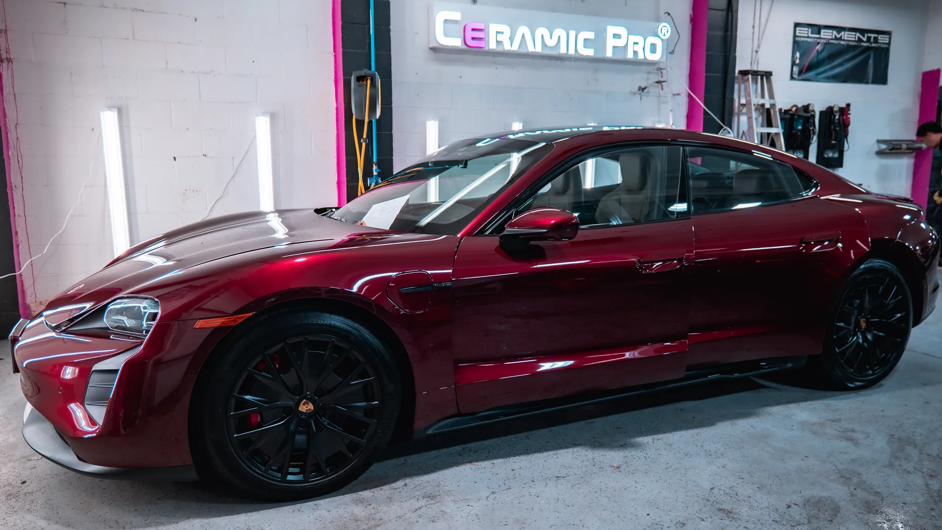 Red Porsche Taycan photographed inside the Elements Labs Vancouver shop after Ceramic Pro ION work.