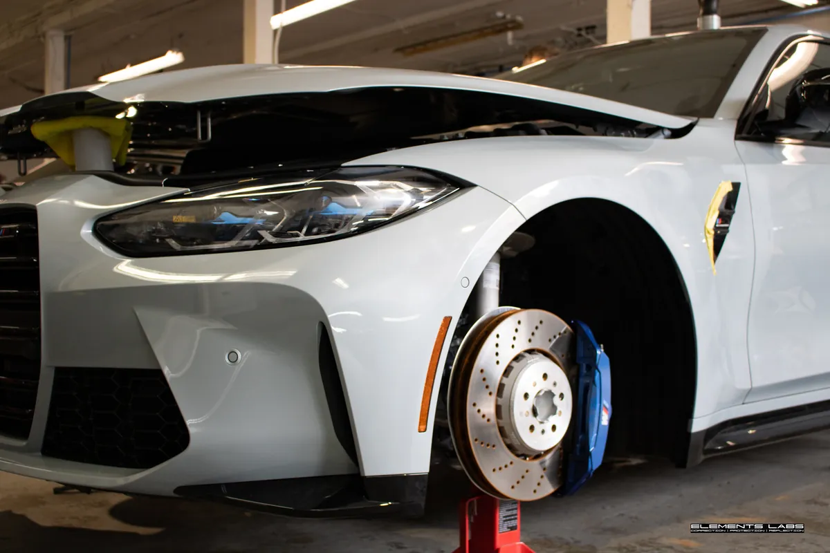 BMW i4 in the Elements Labs shop during wheels-off preparation before graphene coating work.