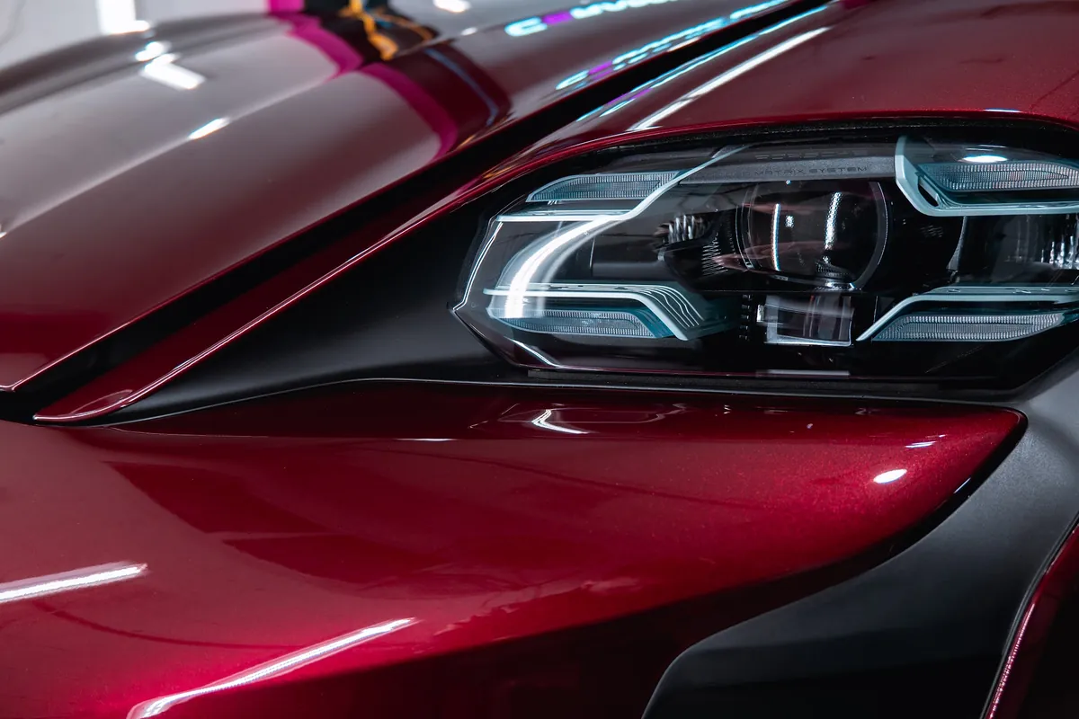 Close view of the red Porsche Taycan finish after Ceramic Pro ION work at Elements Labs.