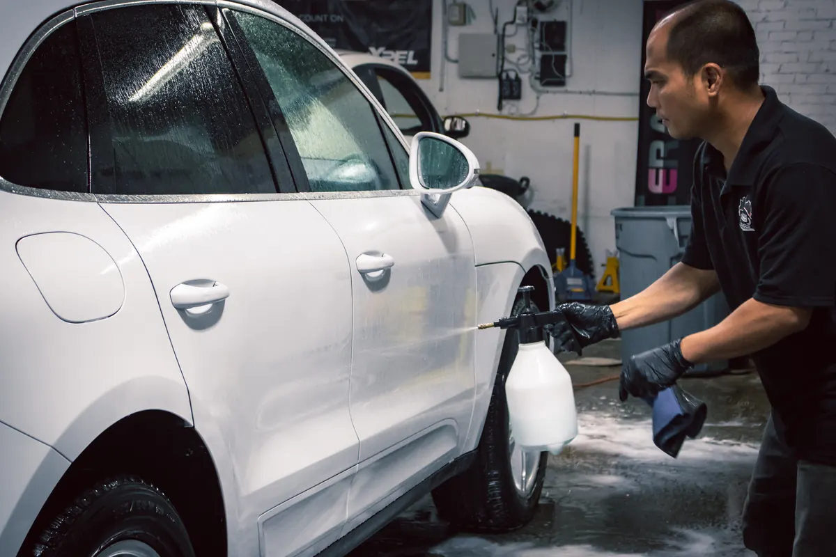 Elements Labs technician applying exterior wash solution to a white vehicle