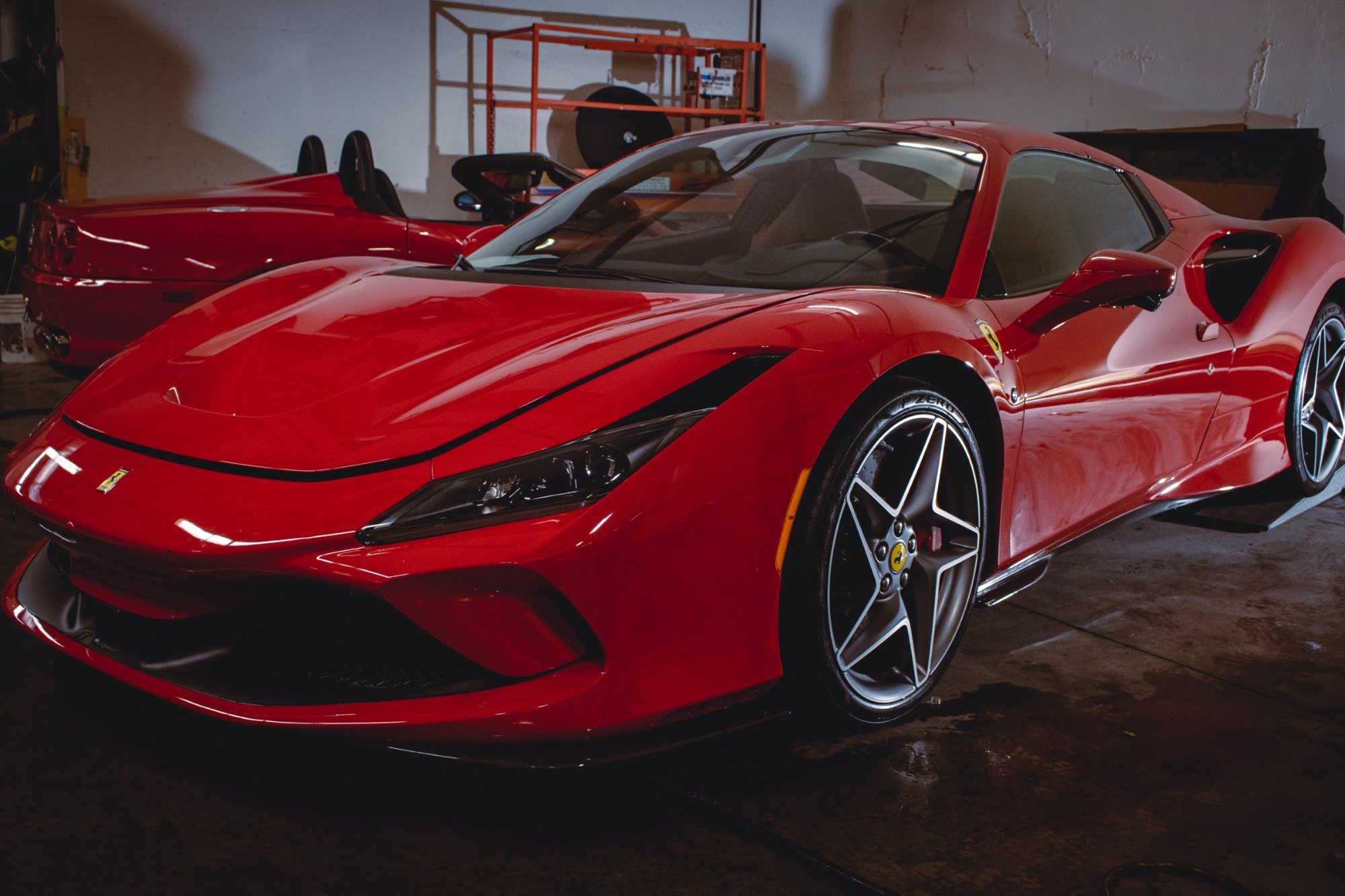 Front three-quarter view of a 2023 Ferrari F8 Tributo Berlinetta after full gloss PPF and Ceramic Pro Ultimate ION at Elements Labs