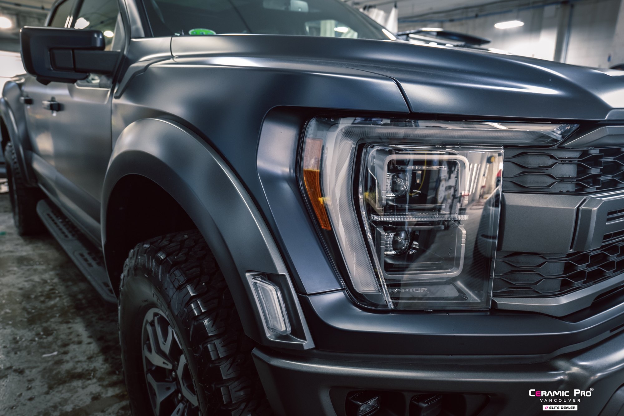Front headlight and fender detail of a 2025 Ford F-150 Raptor after full gloss PPF and Ceramic Pro ION at Elements Labs