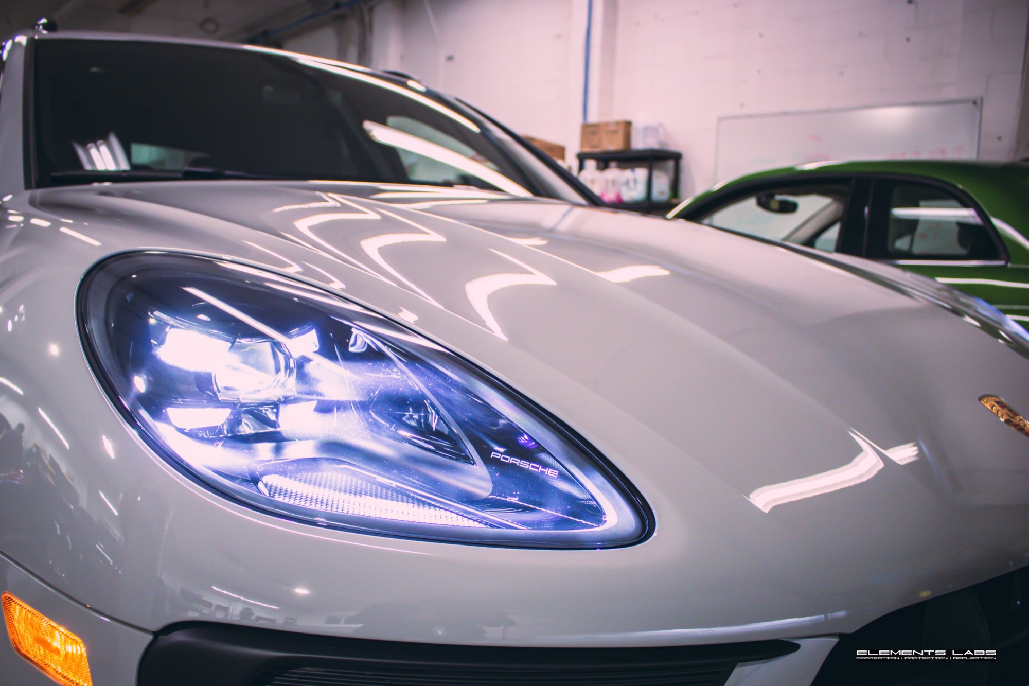 Front headlight and hood detail on a 2024 Porsche Macan GTS after front-end PPF