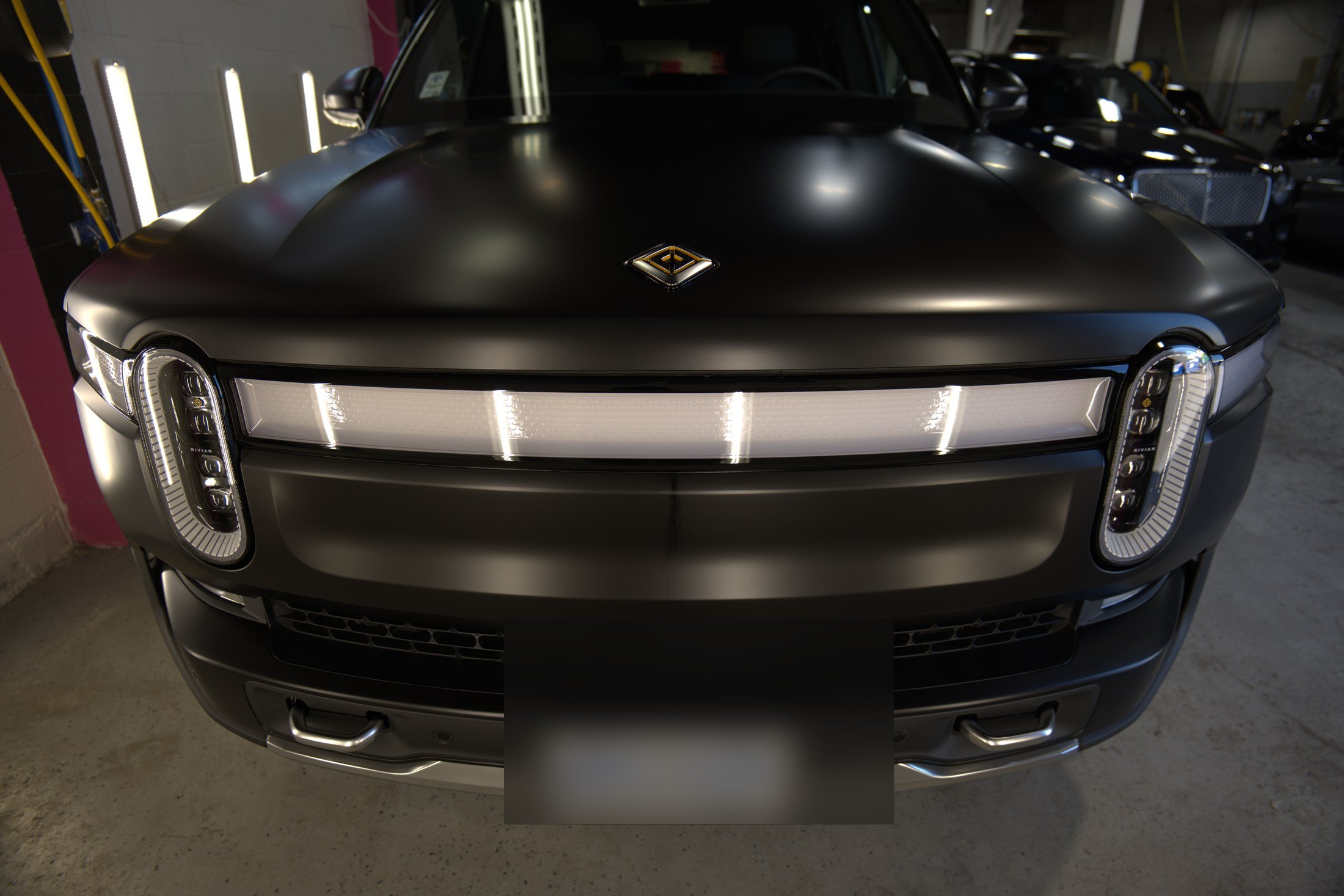 Front detail of a 2024 Rivian SUV after satin PPF