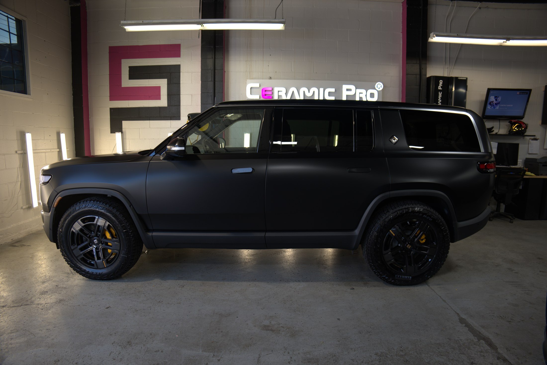 Side profile of a 2024 Rivian SUV after satin PPF installation