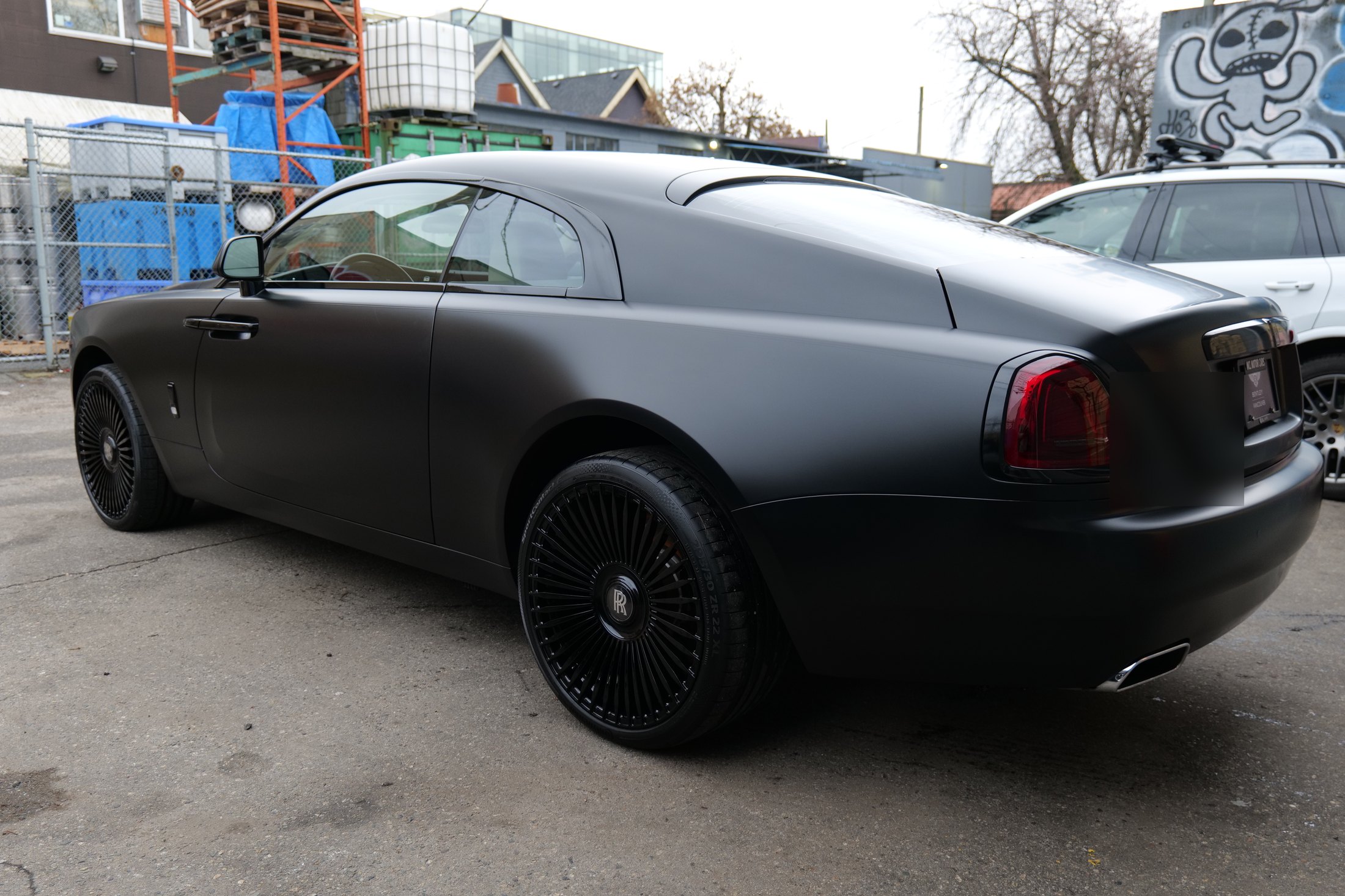 Rear profile of a 2016 Rolls-Royce Wraith with satin black PPF
